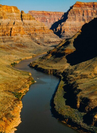 River-Flowing-Through-Arizona-Mountains View of a calm river with mountains in the back